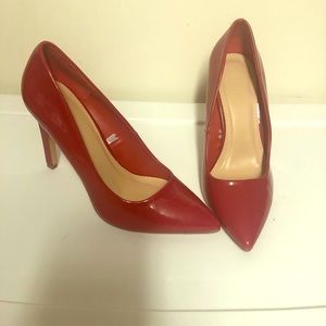 Red patent pumps